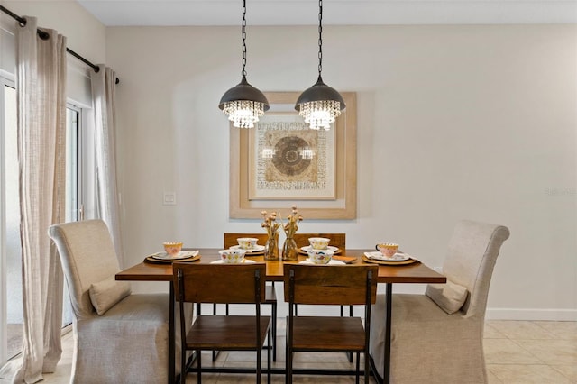 dining room featuring baseboards and light tile patterned flooring