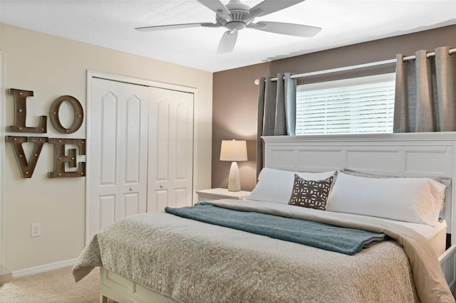 carpeted bedroom with a ceiling fan, baseboards, and a closet