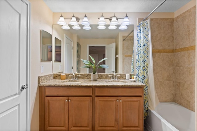 bathroom featuring shower / bath combination with curtain, double vanity, and a sink