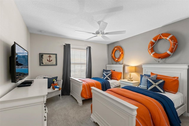 bedroom featuring light carpet, ceiling fan, and a textured ceiling