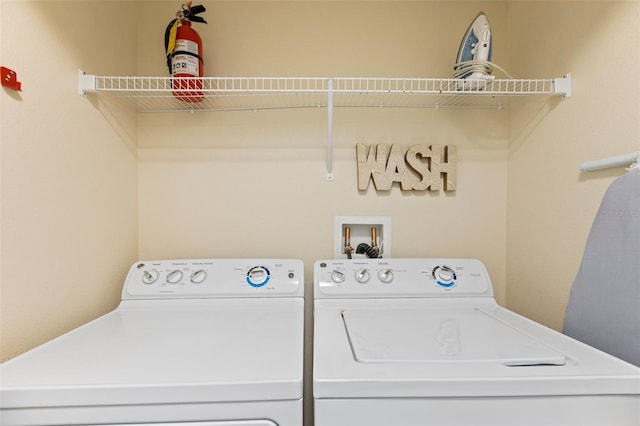 clothes washing area featuring laundry area and separate washer and dryer