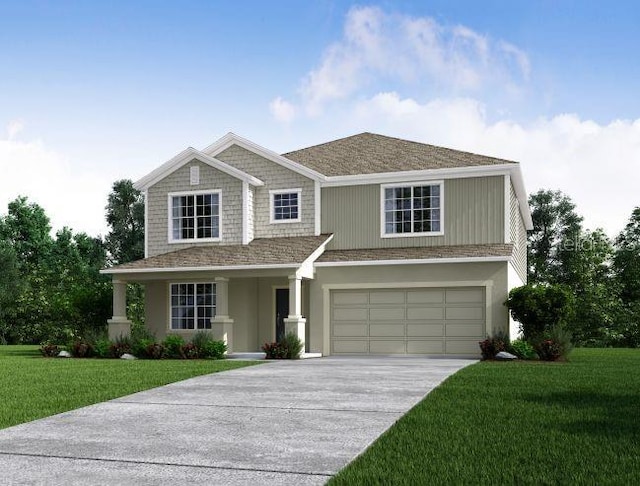 view of front facade with a front yard, driveway, and an attached garage