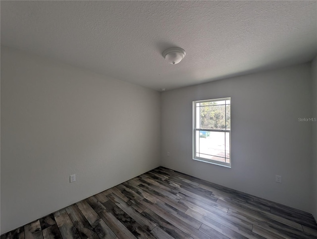 unfurnished room featuring a textured ceiling and dark wood-type flooring