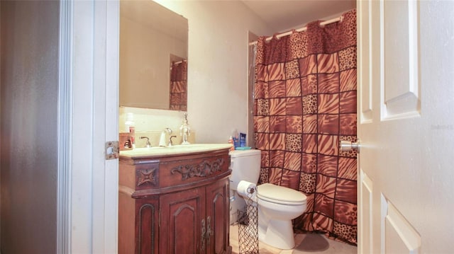 full bathroom featuring vanity, curtained shower, and toilet