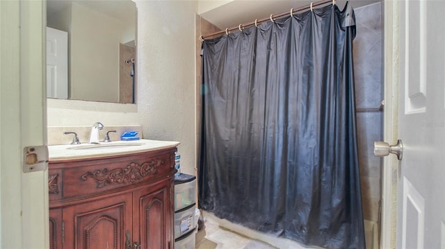 bathroom featuring vanity, a shower with shower curtain, and a textured wall