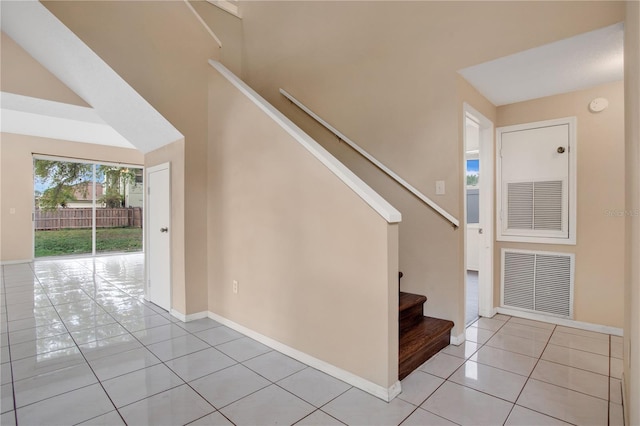 foyer featuring visible vents, stairway, baseboards, and light tile patterned floors