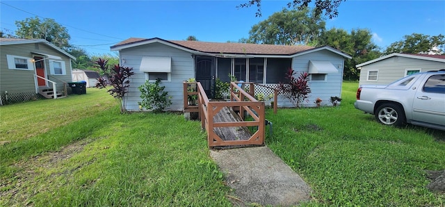 bungalow with entry steps and a front lawn