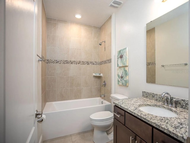 full bath featuring bathtub / shower combination, visible vents, toilet, vanity, and tile patterned flooring