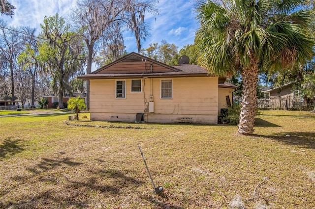 rear view of house featuring crawl space and a yard