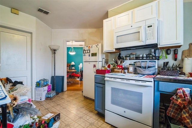 kitchen with light floors, white appliances, visible vents, and white cabinetry