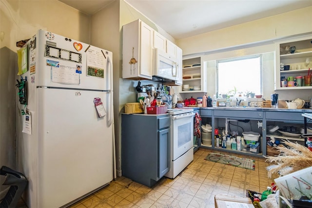 kitchen with white appliances and a sink