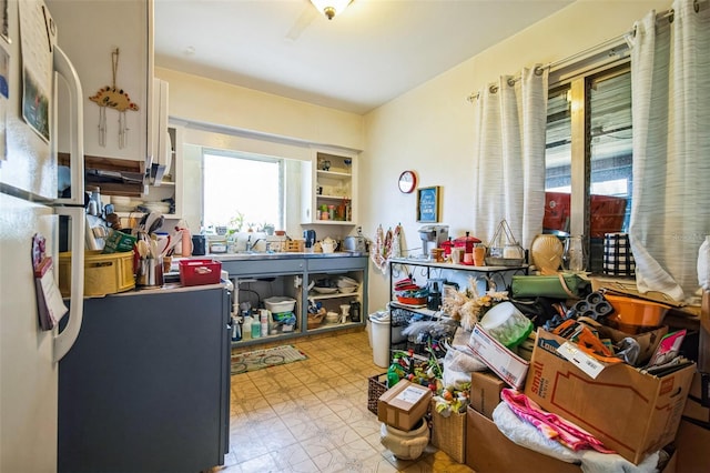 kitchen with freestanding refrigerator, a sink, and tile patterned floors