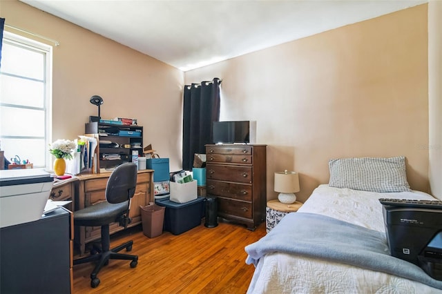 bedroom with wood finished floors