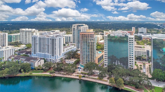 birds eye view of property with a water view and a city view