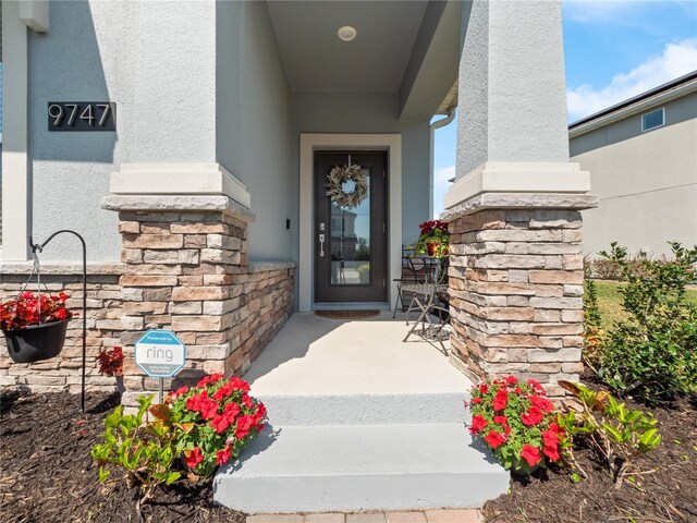 9747 Petition Way, Orlando, FL 32832 - view of exterior entry with stucco siding and stone siding