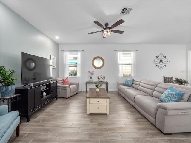 9747 Petition Way, Orlando, FL 32832 - living room with visible vents, wood tiled floor, a ceiling fan, and a healthy amount of sunlight