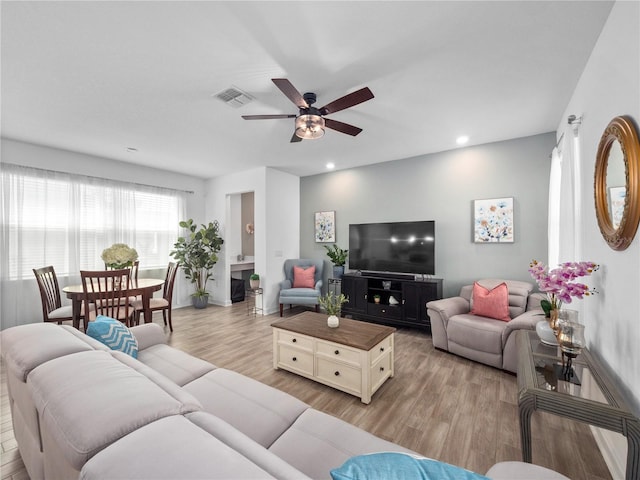 9747 Petition Way, Orlando, FL 32832 - living area featuring visible vents, light wood-type flooring, a ceiling fan, and recessed lighting