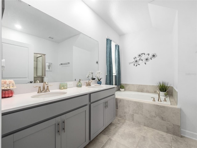 9747 Petition Way, Orlando, FL 32832 - bathroom featuring a bath, double vanity, a sink, and visible vents