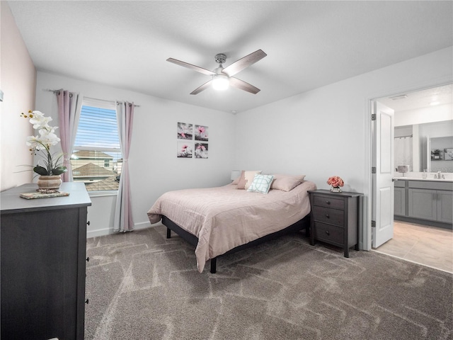 9747 Petition Way, Orlando, FL 32832 - bedroom featuring baseboards, connected bathroom, ceiling fan, light colored carpet, and a sink