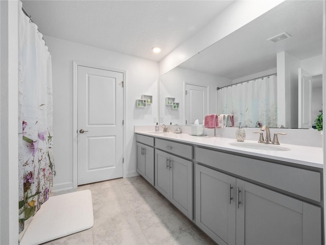 9747 Petition Way, Orlando, FL 32832 - full bathroom with a sink, visible vents, and double vanity
