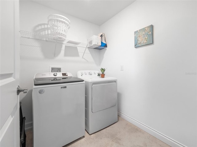 9747 Petition Way, Orlando, FL 32832 - laundry room with laundry area, washing machine and clothes dryer, and baseboards