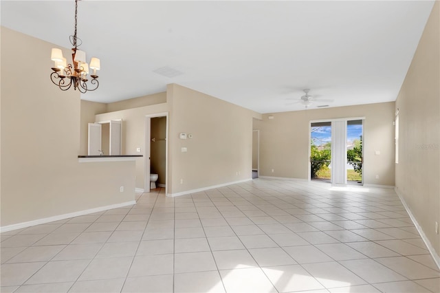 spare room with light tile patterned floors, baseboards, and ceiling fan with notable chandelier