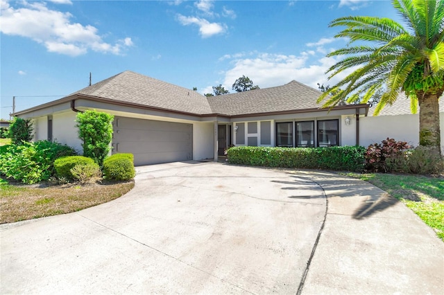 1489 Magellan Cir Unit 603, Orlando, FL 32818 - ranch-style home with driveway, stucco siding, an attached garage, and roof with shingles