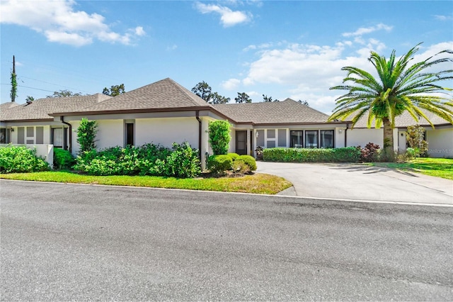 1489 Magellan Cir Unit 603, Orlando, FL 32818 - view of front facade with driveway and stucco siding