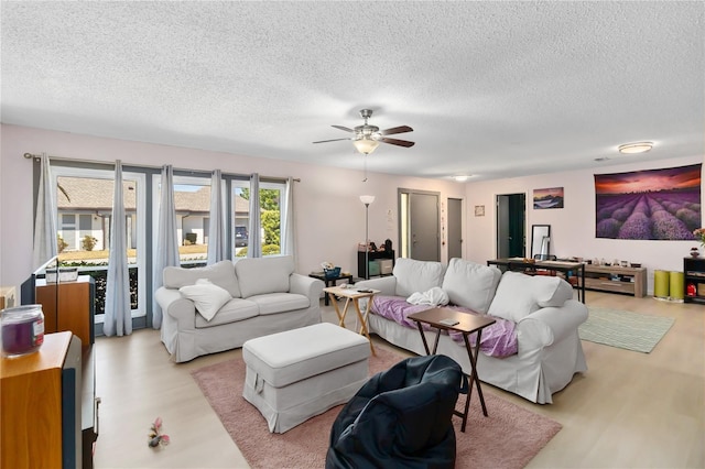 1489 Magellan Cir Unit 603, Orlando, FL 32818 - living area featuring a textured ceiling, light wood-type flooring, and a ceiling fan