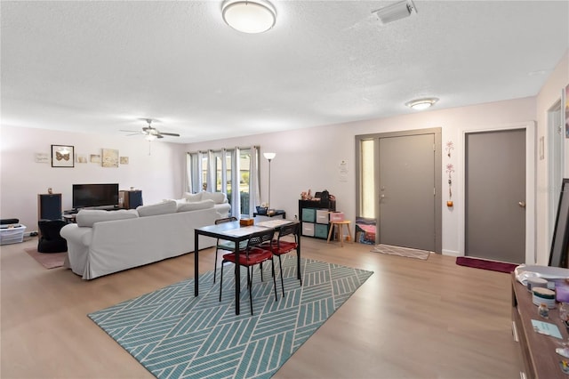 1489 Magellan Cir Unit 603, Orlando, FL 32818 - dining area with visible vents, a textured ceiling, ceiling fan, and wood finished floors