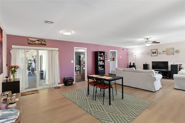 1489 Magellan Cir Unit 603, Orlando, FL 32818 - living room featuring a textured ceiling, visible vents, ceiling fan, and wood finished floors