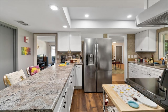 1489 Magellan Cir Unit 603, Orlando, FL 32818 - kitchen with stainless steel refrigerator with ice dispenser, under cabinet range hood, dark wood finished floors, a sink, and visible vents