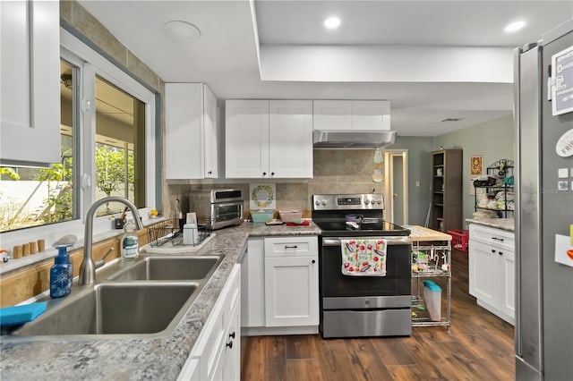 1489 Magellan Cir Unit 603, Orlando, FL 32818 - kitchen with dark wood-style flooring, electric stove, a sink, exhaust hood, and backsplash