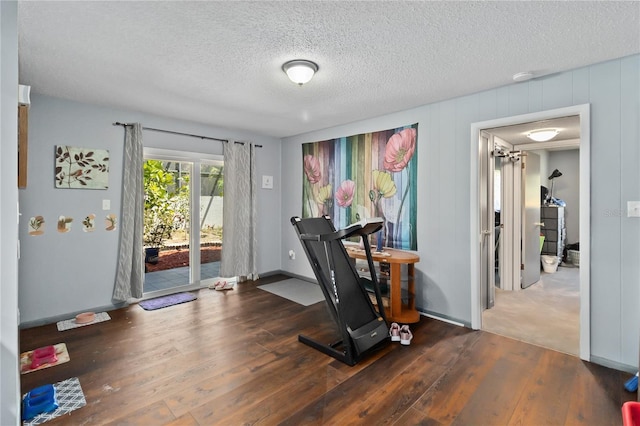 1489 Magellan Cir Unit 603, Orlando, FL 32818 - workout room with baseboards, hardwood / wood-style flooring, and a textured ceiling