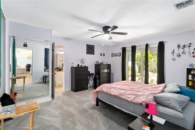 1489 Magellan Cir Unit 603, Orlando, FL 32818 - bedroom featuring a ceiling fan, a textured ceiling, light colored carpet, and visible vents