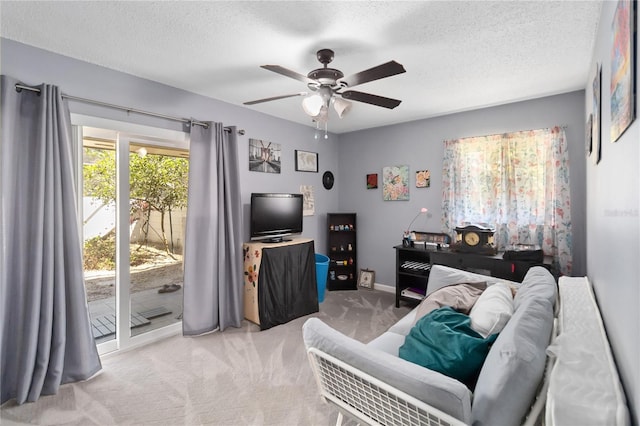 1489 Magellan Cir Unit 603, Orlando, FL 32818 - living area with carpet floors, a textured ceiling, baseboards, and ceiling fan
