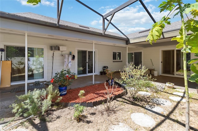 1489 Magellan Cir Unit 603, Orlando, FL 32818 - back of property featuring a shingled roof, glass enclosure, and a patio
