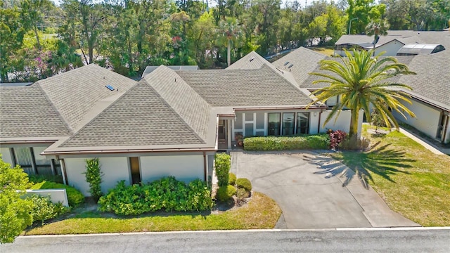 1489 Magellan Cir Unit 603, Orlando, FL 32818 - view of front of house with driveway, stucco siding, and roof with shingles