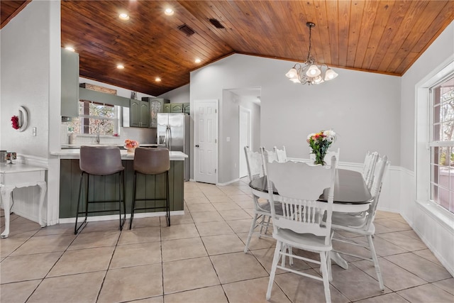 dining room with light tile patterned floors, wood ceiling, and vaulted ceiling