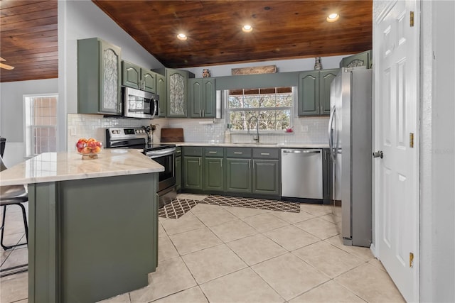 kitchen featuring green cabinets, stainless steel appliances, a sink, and wood ceiling