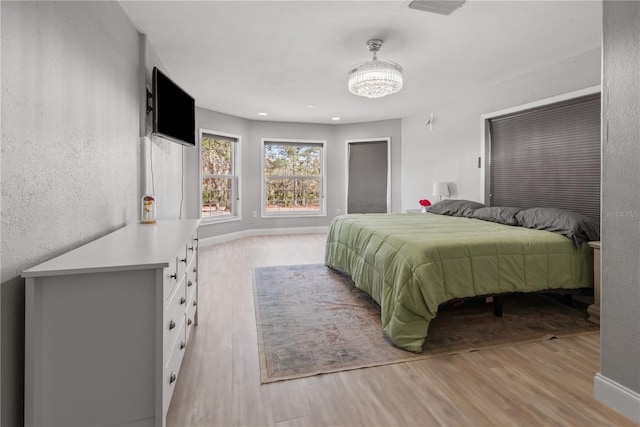 bedroom with light wood-style floors, recessed lighting, and baseboards