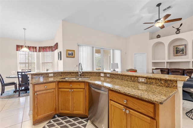 kitchen with lofted ceiling, visible vents, stainless steel dishwasher, open floor plan, and a sink