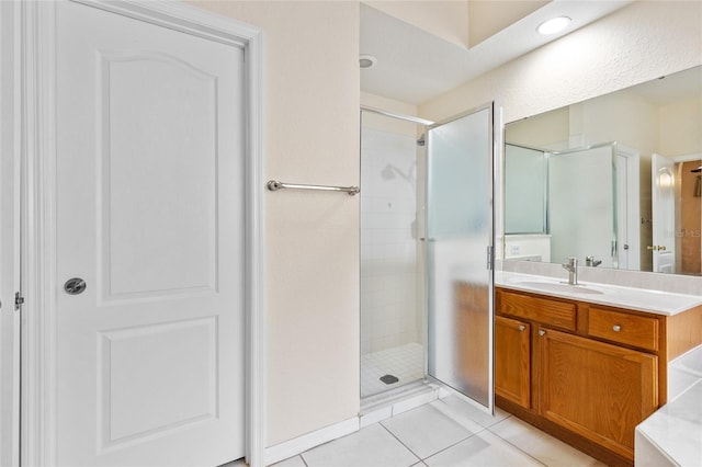 bathroom with tile patterned floors, a shower stall, and vanity