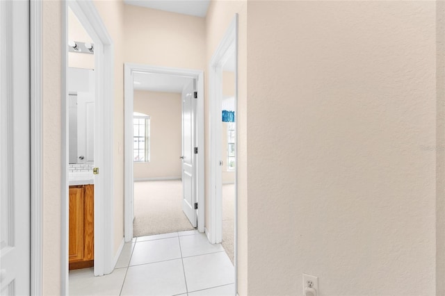 hall featuring light tile patterned flooring