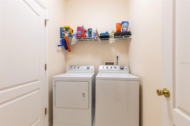 clothes washing area with laundry area and washer and clothes dryer