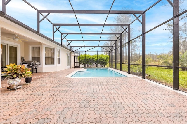 pool with a grill, a lanai, a patio area, and ceiling fan