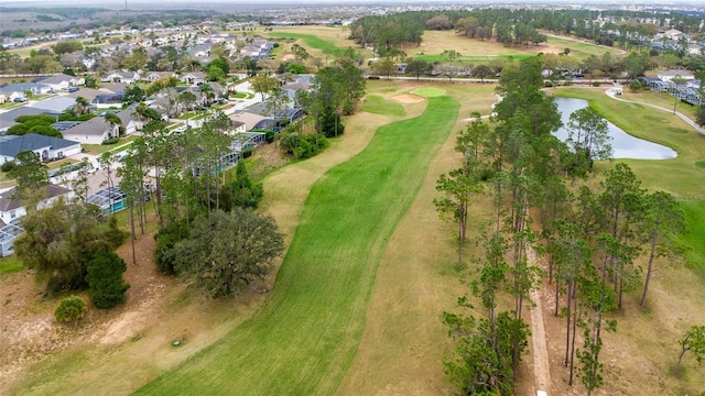 aerial view featuring a water view, view of golf course, and a residential view