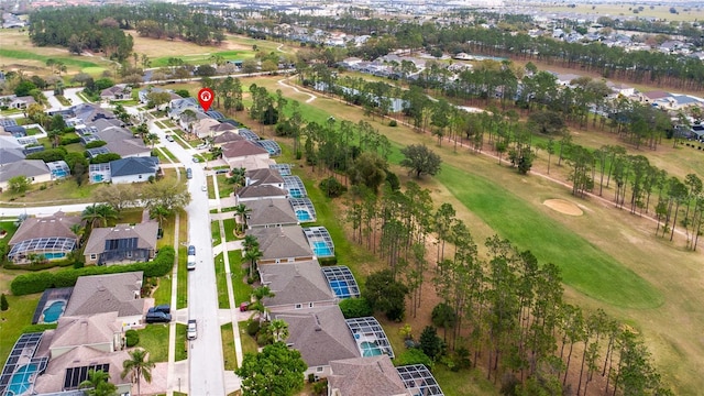 drone / aerial view with golf course view and a residential view