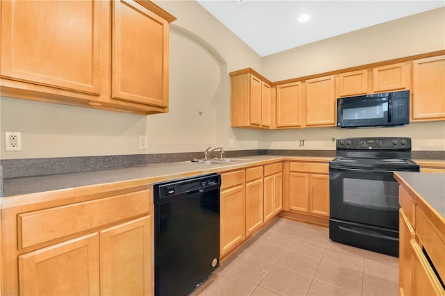 kitchen with light tile patterned floors, recessed lighting, light brown cabinetry, a sink, and black appliances