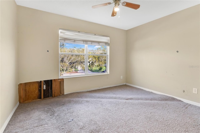 spare room with ceiling fan, baseboards, and carpet flooring